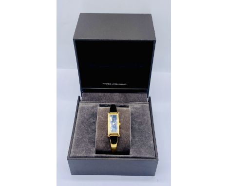 A boxed gold plated Gucci ladies bangle watch, model number 1500L
