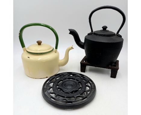 A cast iron kettle, enamel kettle, cast iron trivet and a Coalbrookdale cast iron trivet.