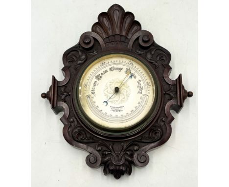 An antique barometer in carved mahogany case by Chadburns Ltd, Liverpool.