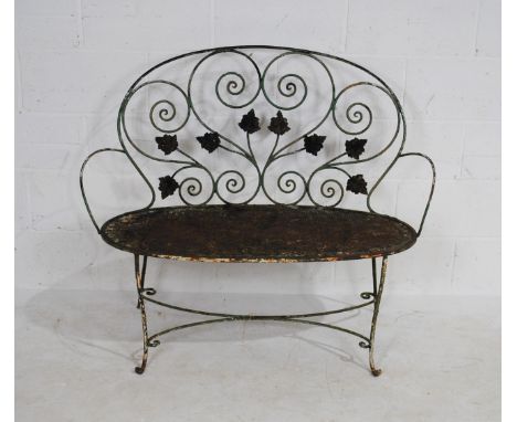 A weathered wrought iron garden bench - length 112cm, height 96.5cm