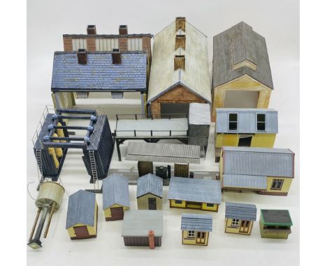 A collection of well-built model railway O gauge buildings including water tower, engine sheds, train wash, various outbuildi