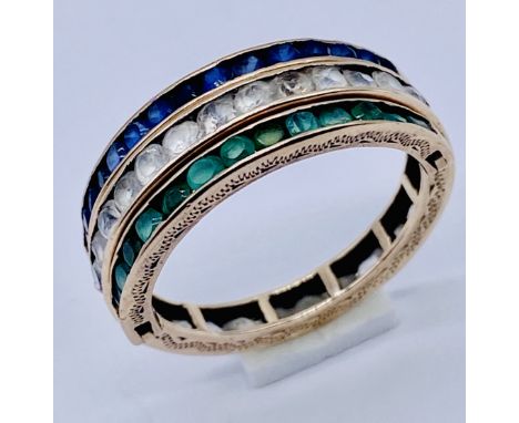 An unmarked gold "Day and Night" ring with a band of  emeralds and blue sapphires, fitted either side are a band of white sap