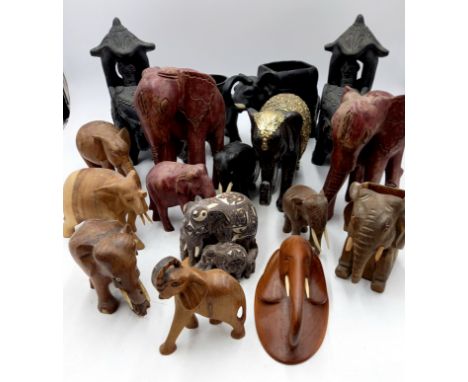 A collection of assorted carved and ceramic elephants 