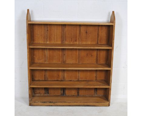 A pine five shelf bookcase with Gothic style detailing, 110 cm wide, 23 cm deep, 127 cm high.