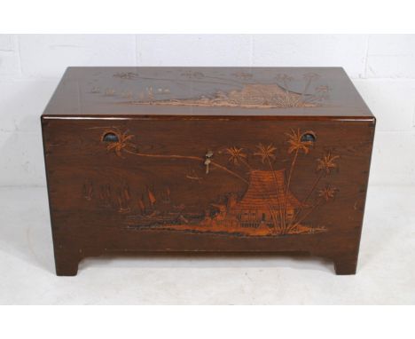 An Oriental camphor wood trunk, with carved detailing and linen tray - length 101.5cm, depth 50.5cm, height 57.5cm
