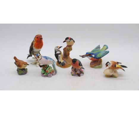 A small collection of Royal Worcester ceramic bird figures, comprising a wren, bullfinch, goldfinch, pied woodpeckers, kingfi