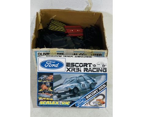 A vintage boxed Scalextric Ford Escort XR3i Racing set, along with a large selection of Scalextric track