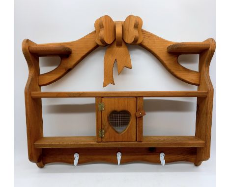 A contemporary pine kitchen wall shelf with bow decoration, 60 cm wide, 50 cm high. 