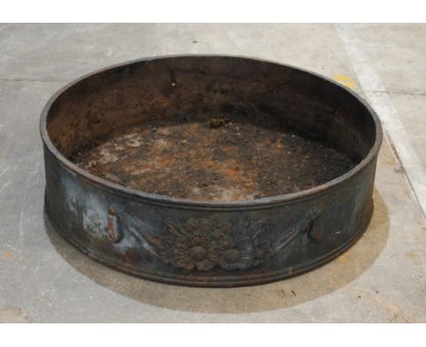 A weathered cast iron circular low garden planter, with classical swag detailing - diameter 59.5cm, height 15cm