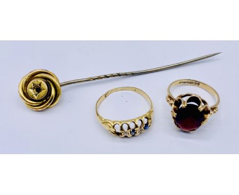 A 9ct gold and garnet ring (size H 1/2) along with an 18ct gold (tested) ring with one stone missing and an 18ct gold stick p