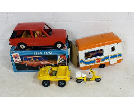 A boxed Pedigree Sindy Range Rover with Sindy doll enclosed (missing steering wheel), along with three other unboxed Sindy ve