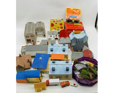 A collection of model railway OO gauge buildings and accessories including stations, engine sheds, houses, factory, trees, st