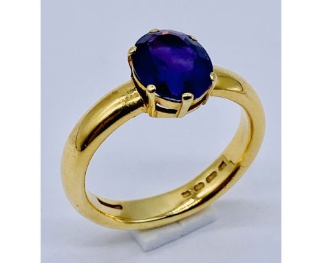 A 22ct gold ring set with an amethyst, size T 1/2, weight 10g