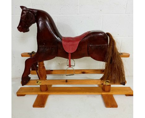 A vintage child's pine rocking horse, 78 cm high, 107 cm length.