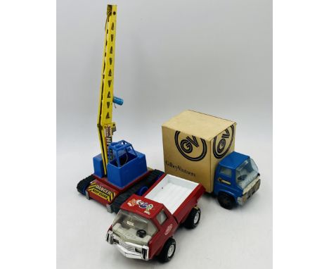 Three vintage toy vehicles including a Marx lorry with Gilbey Vintners box complete with three bottles of spirits (Justerini 