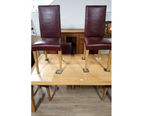 AN EIGHT PIECE LIGHT OAK DINING ROOM SUITE INCLUDING TABLE, SIDEBOARD AND SIX RED LEATHERETTE CHAIRS