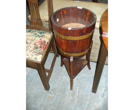 An Early 20th Century oak and brass banded planter by " B A Lister & Co Ltd , Bursley" , raised on three curvilinear supports