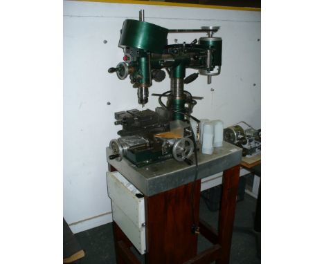 A Leeson modelers milling machine raised on a hardwood bench.