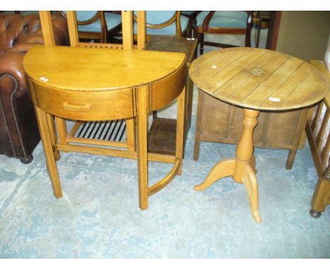 A Circular oak commemorative tripod table and a half moon hall table with a single frieze drawer. (2)