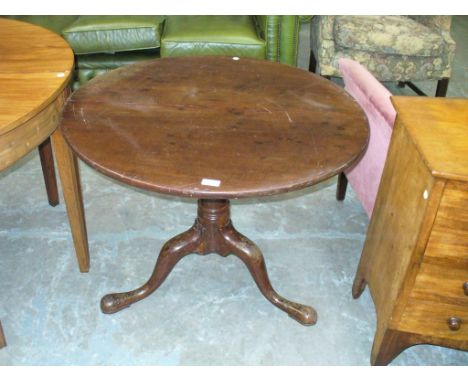 A Georgian mahogany tripod table on a ring turned shaft.