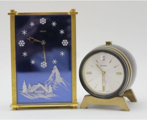 A 'JAEGER' MUSICAL ALARM CLOCK, blue face with alpine scene and snowflake batons, 8-day movement, No. 2161, bears paper label