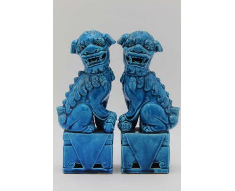 A PAIR OF LATE 20TH CENTURY CHINESE CERAMIC DOGS OF FO, raised on plinth bases, turquoise glaze, 20cm high 