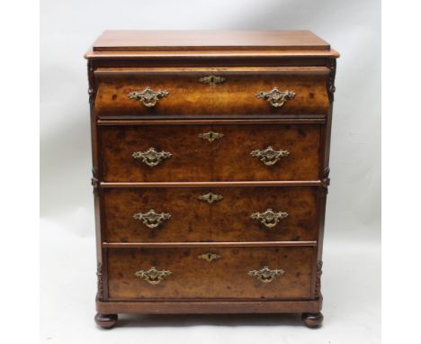 A CONTINENTAL DESIGN FOUR DRAWER CHEST having walnut front with fancy cast drop handles & escutcheons, housed between floral 