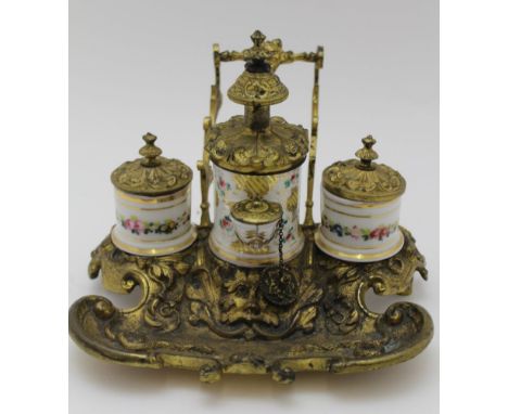 A LATE 19TH CENTURY CONTINENTAL STANDISH, the gilded cast brass frame with pen upstand, tray to the front with green man mask