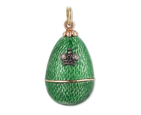 A green guilloché enamel egg pendant, the body of the egg enamelled to resemble snakeskin and applied with a diamond-set crow
