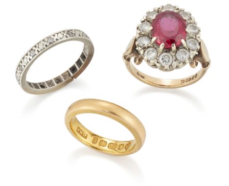 A group of three rings, comprising: a 22ct gold wedding ring, London hallmarks, 1953, coronation mark, ring size H½; a 9ct go