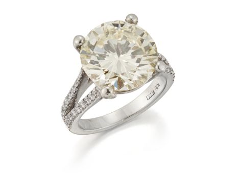A diamond single stone ring, the round brilliant-cut diamond weighing 6.20 carats, in four claw-mount, with brilliant-cut dia