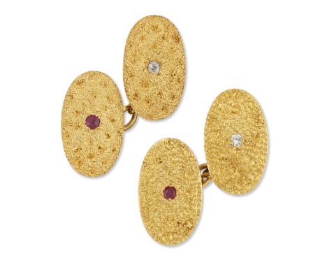 A matched pair of ruby and diamond cufflinks, oval panels set to the centre with a brilliant-cut diamond or round-cut ruby, w