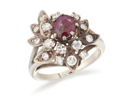 A ruby and diamond cluster ring, the oval mixed cut ruby to spray of Swiss-cut, brilliant-cut and single-cut diamonds, ring s