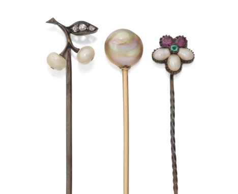 Three gem stick pins,&nbsp;comprising: a rose-cut diamond and seed pearl pin; an emerald, ruby and pearl flowerhead cluster p