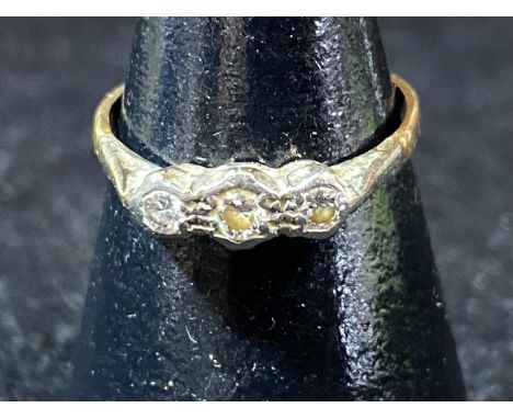 A 9ct gold and three stone diamond ring. 1.38 grams 