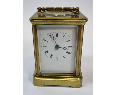 A brass striking carriage clock, the white enamel dial with Roman numerals, the movement striking on a bell, 11.5 x 8.5cm.