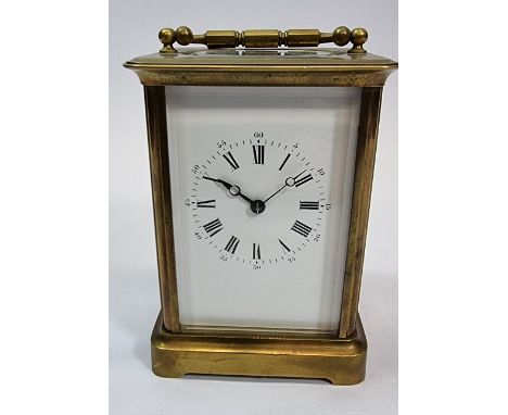 A brass carriage clock, the white enamel dial with Roman numerals, the movement numbered 98, 13 x 10cm