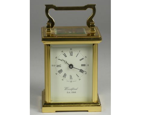 A brass carriage clock, the enamel dial signed Woodford, Est 1860, Roman numerals, the movement signed Alain Movement, 11 x 8