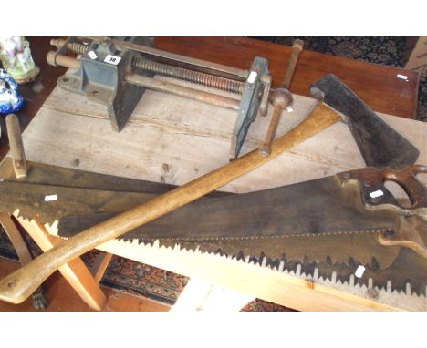 Record bench vice, a large axe, and three cross-cut saws