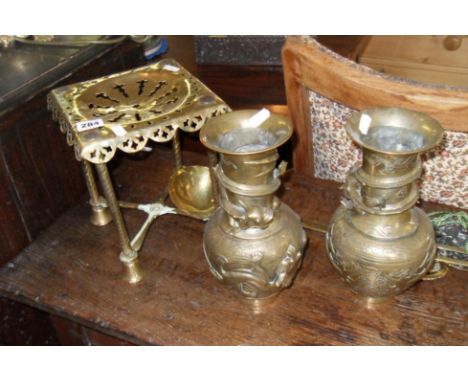Victorian brass trivet, a pair of Chinese bronze dragon vases, brass ladle and some horse brasses
