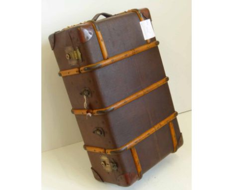 An early 20th century travel trunk or case, with wooden mounts and brass locks, painted with the initials G.A.Y, with leather