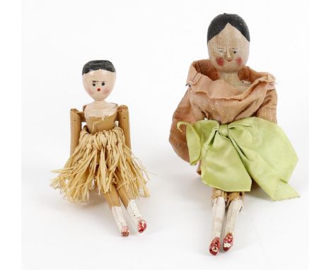 
	
		Two part painted softwood peg dolls, the first possibly late Victorian, painted face, lacking right arm, 25.5cms high; s