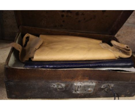 Case with vintage leather wood working tools and pieces of leather