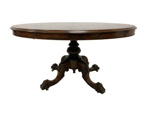 Mid-to late century walnut loo table, oval top with moulded edge and quarter match finish, fluted and turned pedestal with fo