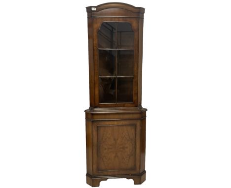 Mid 20th century walnut corner cabinet, fitted with one glazed door opening to reveal two shelves over one cupboard door with