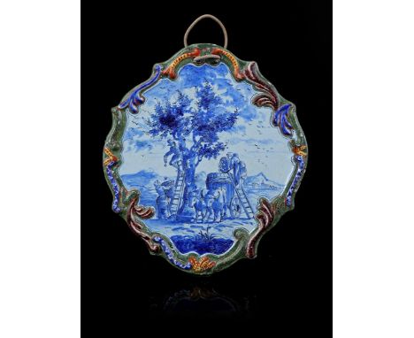 Delftware plaque with polychrome decoration of farmers during apple cultivation, marked 'De Witte Ster' and H.F., after an an