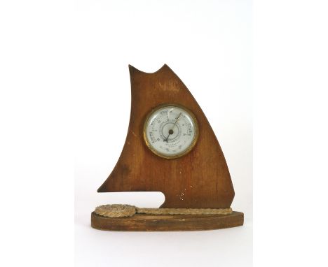 A Weathermaster barometer, the wooden case in the form of a sailing boat, 21cm 