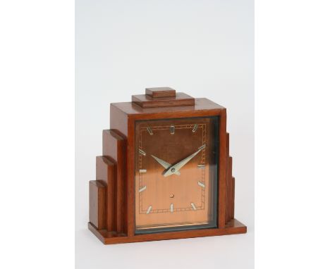 An Art Deco electric mantel clock, with stepped mahogany case and copper dial, 19cm 