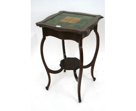 An Art Nouveau mahogany tile topped occasional table