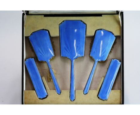 An Art Deco silver plated and blue enamel five piece dressing table set, in fitted box 